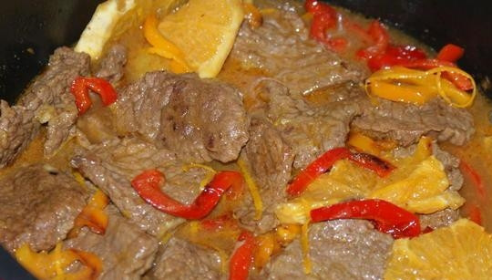 1. Этап. Говядина, тушенная со сладким перцем: Когда из мяса выпарится вся жидкость, добавьте к нему соус, перец и апельсин. Доведите до кипения.
