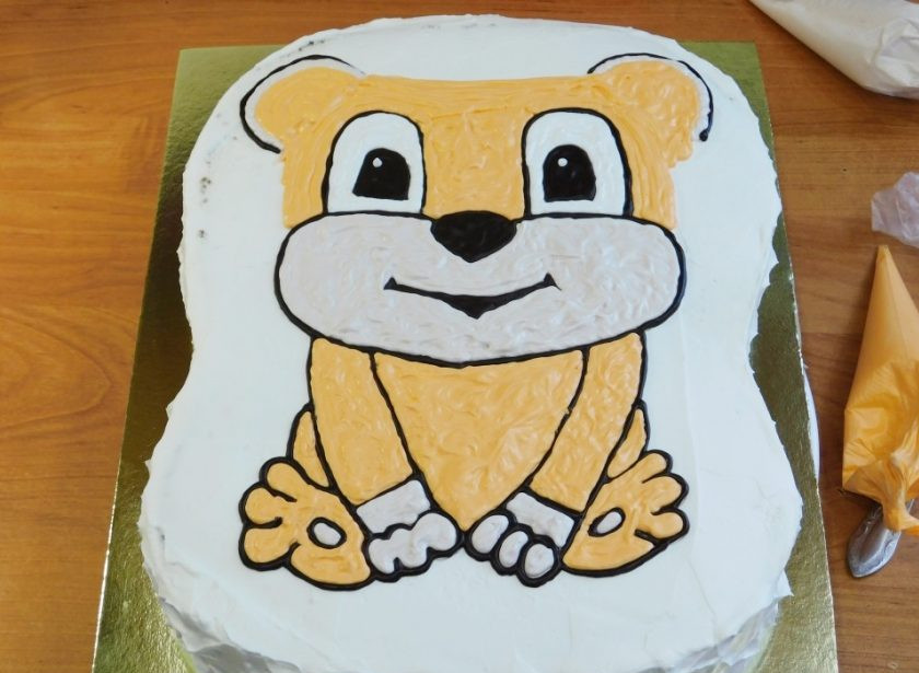 1. Этап. Торт Львенок: С помощью пищевого красителя окрасьте немного крема и начинайте заполнять поверхность так, как на фото.