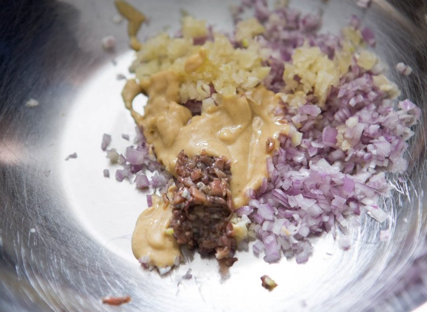 1. Этап. Салат с консервированным тунцом и яйцом: 5. Для заправки: мелко нарезаю лук-шалот, выдавливаю зубчик чеснока, добавляю горчицу, измельченные анчоусы, винный уксус, воду. Взбиваю все венчиком и вливаю тонкой струйкой оливковое масло, по вкусу солю и перчу.