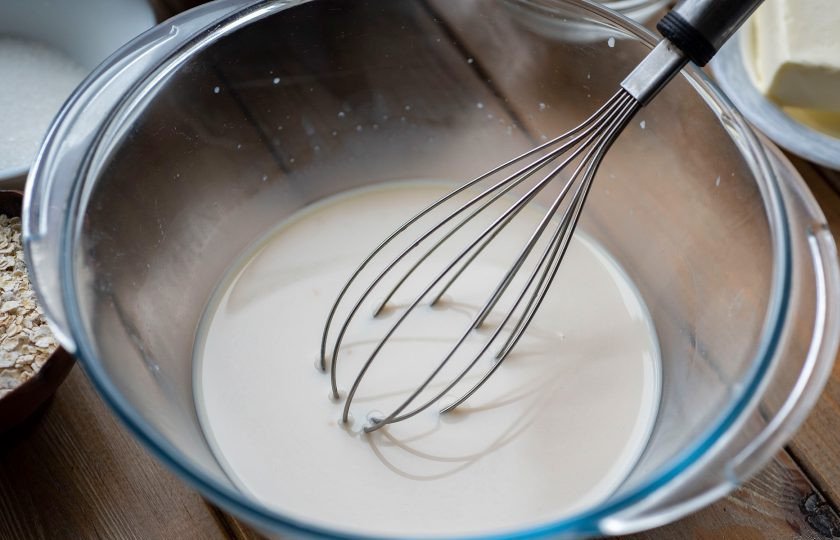 1. Этап. Булочки с овсяными хлопьями: Залейте теплое молоко и активно перемешайте эти ингредиенты до полного растворения дрожжей.