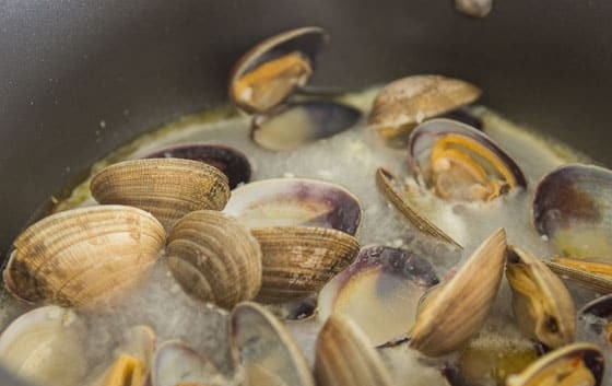 1. Этап. Спагетти с моллюсками: 2. Отварите спагетти в подсоленной воде почти до готовности. Отправьте сковороду на огонь, влейте оливковое масло, добавьте измельченный чеснок и чили, обжаривайте до появления приятного аромата. Выложите мидии и влейте вино, накройте сковороду крышкой и готовьте до их открытия.