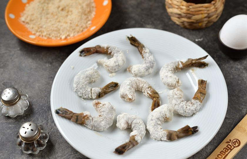 1. Этап. Креветки в панировке на сковороде: Обваляйте все хвосты в муке.