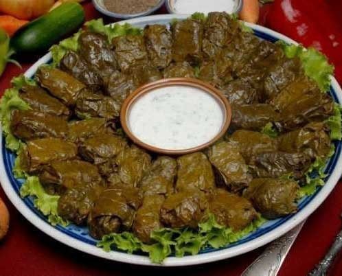 1. Stage. Dolma: Make the sauce. Wash, dry and chop greens. Peel and finely chop the garlic. Combine sour cream with garlic and herbs, salt to taste and mix. Cool the sauce well in the refrigerator for 2 hours. Serve hot dolma with sauce.