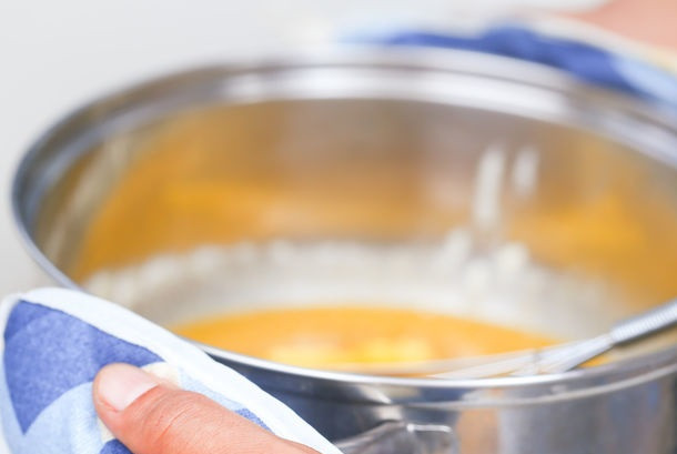 1. Этап. Домашняя карамель из сахара: 4. Снять карамель с огня и немного остудить. Добавить сливочное масло и начать активно перемешивать. Затем постепенно добавить сливки, продолжая мешать.