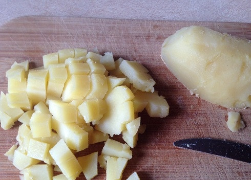 1. Этап. Салат из кальмаров с грибами: Картофель для салата лучше использовать сваренный в кожуре. Очищаем его и нарезаем.