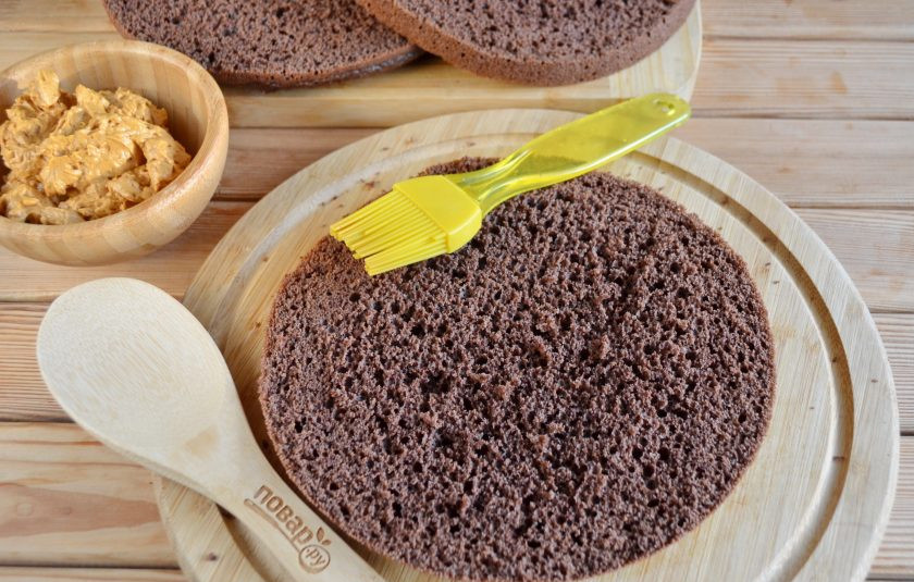 1. Этап. Шоколадный торт с орехами: 10. Полностью остывший бисквит с помощью острого ножа или нитки (или кулинарной лески) разрежьте на три части вдоль. Приготовьте пропитку, для этого доведите до кипения сахар с водой, остудите полностью и влейте коньяк. Перемешайте. С помощью распылителя или кисточки щедро пропитайте коржи.