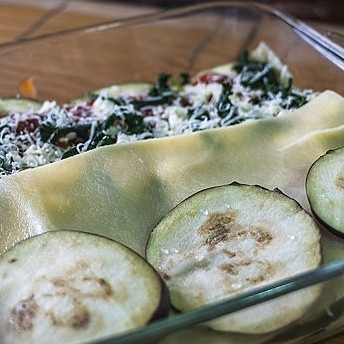 1. Этап. Лазанья с баклажанами: 6. В миске смешайте творог с измельченным шпинатом, солью и перцем. Приготовьте любимый соус. На дно формы для запекания выложите пятую часть соуса. Затем выложите слой из листьев лазаньи, слой из баклажанов, слой из смеси с творогом, снова - соус, лазанья и т.д.