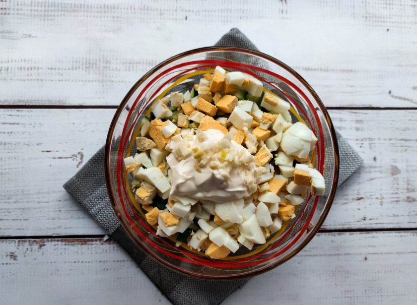 1. Этап. Салат Калейдоскоп с крабовыми палочками: Заправьте салат майонезом, добавьте соль, мелко нарезанный чеснок и хорошо перемешайте.