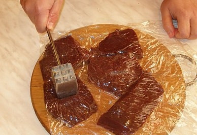 1. Этап. Отбивные из печени: Чтобы отбить печенку, воспользуемся пищевой пленкой - уложим куски печени между двумя слоями, перенесем на разделочную доску и легонько отобьем молотком с обеих сторон. Потом пленку аккуратно снимем и выбросим, а печенку переложим в миску. Этим способом вы также можете отбивать мясо и птицу, но именно приготовление отбивных из печени наглядно иллюстрирует все его преимущества - без пленки рабочее место было бы далеко не таким чистым;).