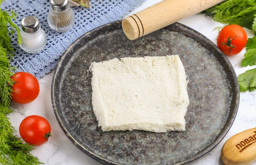 1. Этап. Пирожки из тостового хлеба: Мякоть раскатайте скалкой в разные стороны аккуратно, но не сильно тонко, чтобы она не порвалась.