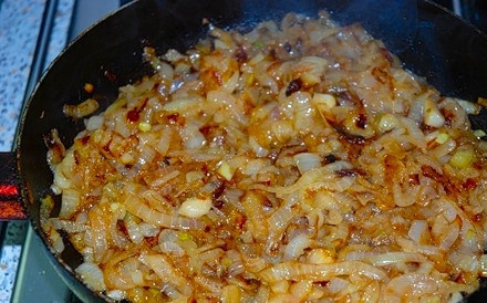 1. Этап. Сазан жареный с луком: 5. На отдельной сковороде разогрейте масло. Очистите лук и нарежьте тонкими полукольцами. Выложите на сковороду и жарьте до глубокого золотистого цвета. Рекомендую использовать в рецепт приготовления сазана жареного с луком около килограмма, так как он прекрасно сочетается с рыбой. По желанию его можно подсолить немного или добавить специи.