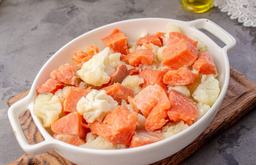 1. Этап. Запеканка из цветной капусты и семги: Форму для выпечки смажьте растительным маслом, выложите капусту и рыбу.