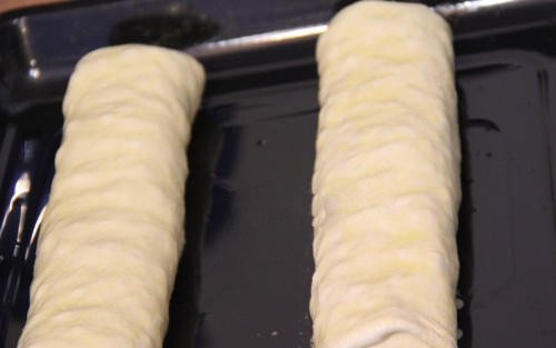 1. Этап. Яблочный штрудель простой: Аккуратно сверните тесто в рулет. Нужно быть предельно внимательным, так как такое тонкое тесто может запросто порваться. Смажьте рулет сливочным маслом.