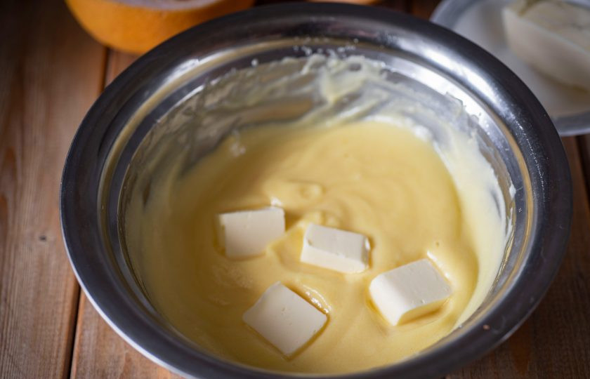 1. Этап. Грейпфрутовый курд: Добавляйте мягкое масло, нарезанное кусочками.