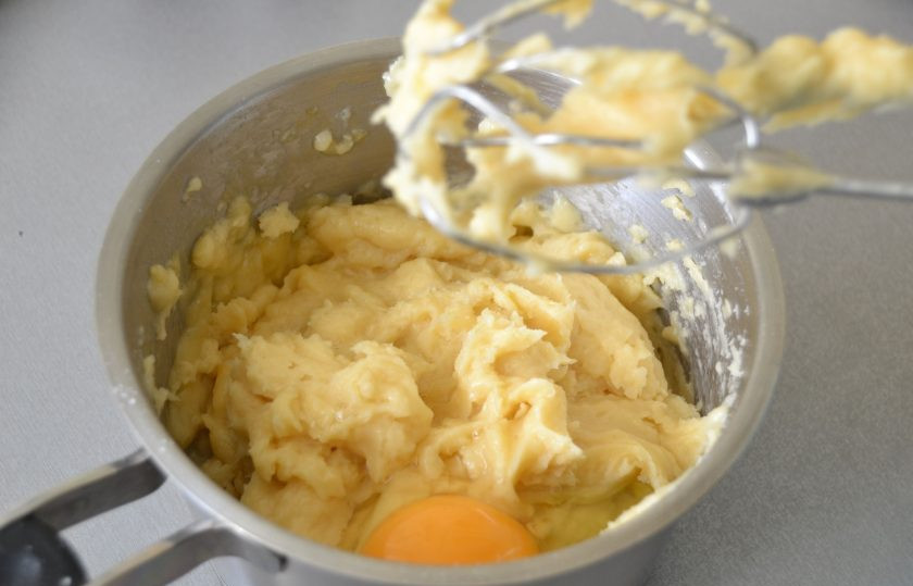 1. Этап. Глазурь для эклеров: По одному введите в тесто 250 грамм яиц, это примерно 4 штуки, каждое яйцо тщательно вмешивайте в тесто, можно пользоваться миксером.