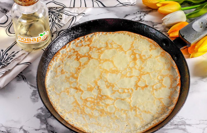 1. Этап. Блины с клюквенной начинкой: Прогрейте блинную сковороду и смажьте ее растительным маслом в первый раз. Влейте часть теста и округлите, испеките блин по 1 минуте с каждой стороны.