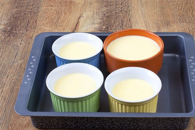 1. Этап. Крем Каталана: Разогрейте духовку до 165 градусов. В поддон для запекания налейте 2 см воды. Поставьте в него 4 формы и разлейте по ним будущий крем.