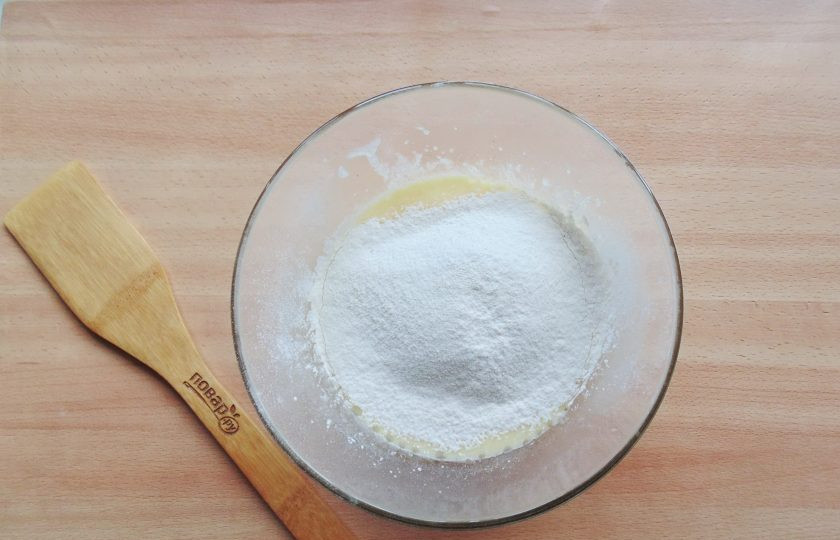 1. Этап. Простой ягодный пирог: Всыпьте в тесто просеянную муку и разрыхлитель.
