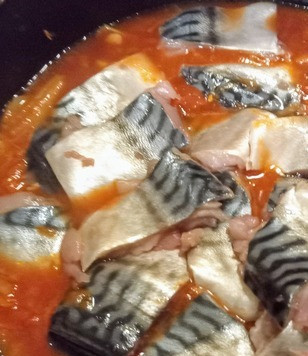 1. Этап. Скумбрия в томатном соусе: Добавить 150 мл воды. Выложить кусочки рыбы.