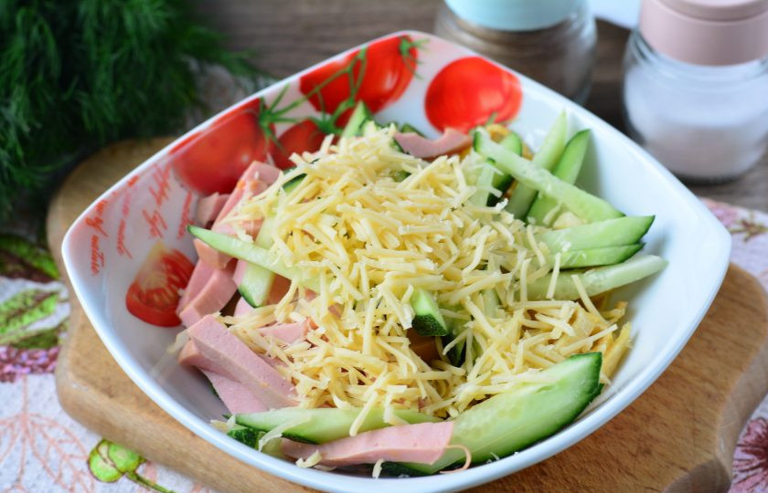 1. Этап. Салат из омлета и колбасы: Добавьте в салат тертый сыр.