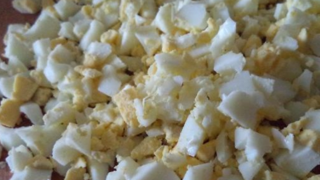 1. Этап. Салат из кальмаров с рисом: Яйца очищаем и нарезаем мелким кубиком.