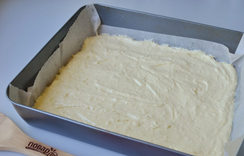 1. Этап. Кокосовые пирожные со сгущенкой: 6. Форму для выпечки (25 на 25, 22 на 27) застелите пергаментом, выложите тесто и разровняйте лопаткой, отправьте выпекаться на 10-12 минут.