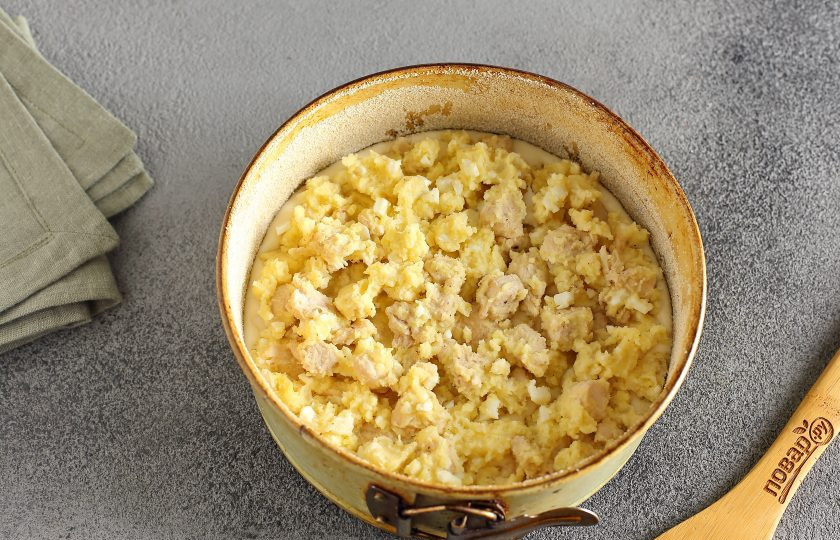 1. Этап. Невесткин пирог: Форму для запекания смажьте маслом. Дно и бока обсыпьте мукой или манкой (размер моей формы 18 см. в диаметре). Налейте половину порции теста и сверху равномерно распределите всю начинку.