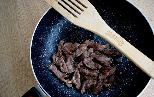 1. Этап. Кхау Пхат: Пока варится рис, займитесь мясом. Нарежьте его мелкими полосками. Обжарьте на разогретом масле до готовности.