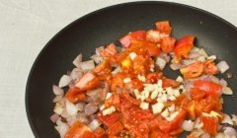 1. Этап. Вегетарианский суп-пюре из чечевицы: К луку добавить томаты и чеснок. Обжаривать 3-5 минут.