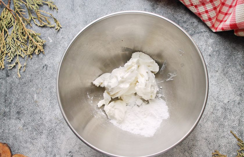 1. Этап. Миндальные капкейки: Для крема выложите в миску рикотту и всыпьте сахарную пудру. Взбейте до пышности.