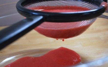 1. Этап. Земляничное пюре: Затем берем чистое сито и выкладываем в него с помощью чистой столовой ложки перемолотые ягоды. Протираем через него всю земляничную кашицу прямо в чистую глубокую миску.