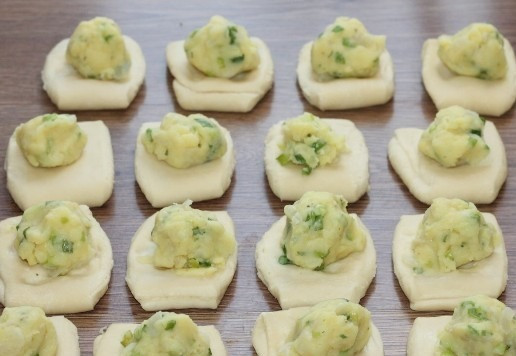 1. Этап. Слоеные пирожки с луком и картошкой: 13. Раскатываем каждую часть заготовки (слегка) в 1,5 раза. Кладем начинку (по 1 ст. л.), закрываем и собираем край.