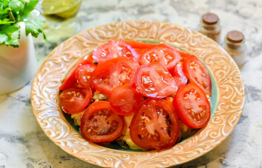 1. Этап. Салат Красная шапочка с помидорами: Украсьте салат нарезанными помидорами и подавайте к столу.