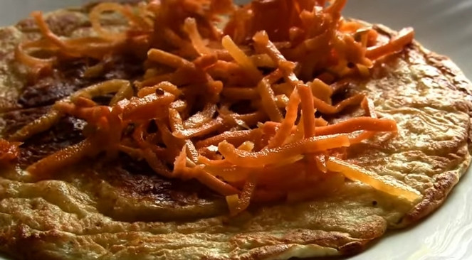 1. Этап. Закусочный торт с морковью без майонеза: 5. Теперь начните собирать торт. На блинчик выложите слой корейской морковки. И чередуйте эти слои. На верхний блин выложите тертый сыр.