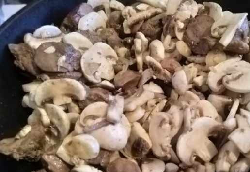 1. Этап. Куриная печень с грибами и сметаной: Грибы нарезать пластинами, довольно тонко. Слегка посолить и выложить к печени, здесь можно добавить чеснок. Тушить всё вместе минут 5-7. Грибы дадут сок.