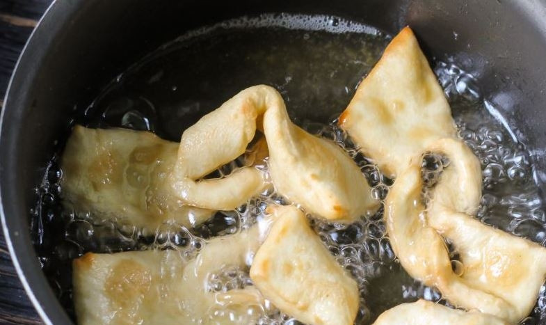 1. Этап. Хворост простой: В кастрюле или в казанке разогрейте растительное масло. Его должно быть достаточное количество. Обжаривайте в нем кусочки теста до золотистого цвета. Затем выложите их на бумажную салфетку, чтобы впитался лишний жир. Переложите хворост на блюдо и посыпьте все сахарной пудрой.