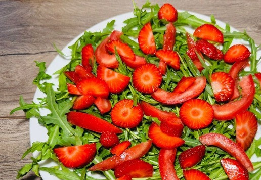 1. Этап. Салат Яркое настроение: Раскладываем клубнику поверх рукколы и помидора.