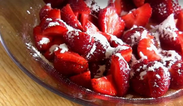 1. Этап. Клубничный кекс с шоколадной глазурью: 1. Клубнику помойте и очистите от хвостиков. Разделите на 2 части. Одну перебейте блендером. Клубнику второй части разрежьте на четвертинки и присыпьте сахарной пудрой.