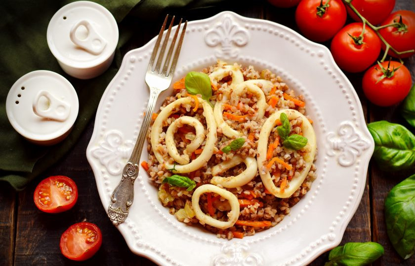 1. Этап. Гречка с кальмарами: Готовое блюдо переложите в тарелку, добавьте сливочное масло, украсьте зеленью.