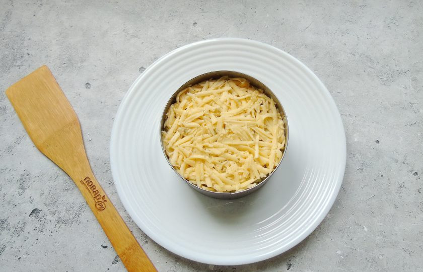 1. Этап. Слоеный салат Лесная поляна с маринованными опятами: Любой твердый сыр по вкусу натрите на терке. Это следующий слой. Смажьте майонезом.