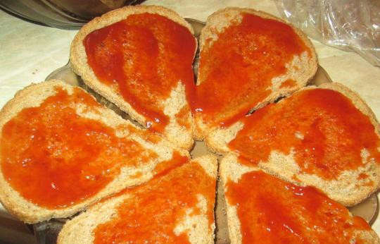 1. Этап. Бутерброды с фаршем в духовке: Намазываем ломтики хлеба кетчупом.