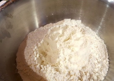 1. Этап. Манты из тыквы: Просеиваем в миску муку, добавляем соль.