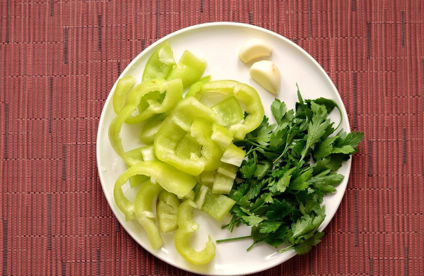 1. Этап. Закусочные помидоры: Болгарский перец помойте, удалите хвостик и семена. Чеснок очистите, а у петрушки отрежьте стебли.