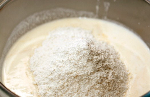 1. Этап. Тесто на блины на кефире: Просеиваем муку прямо в миску с кефиром и яйцами. В горку муки кладем чайную ложку соды. Все тщательно размешиваем, чтобы не осталось комочков.