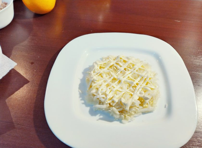 1. Этап. Салат с куриным филе Рандеву: Когда все составляющие салата подготовлены, можно начинать выкладывать слой за слоем. Сначала выкладываем капусту, смазываем майонезом.