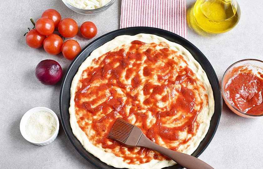 1. Этап. Пицца с шампиньонами: Смажьте тесто томатный соусом. Удобно это делать кисточкой.