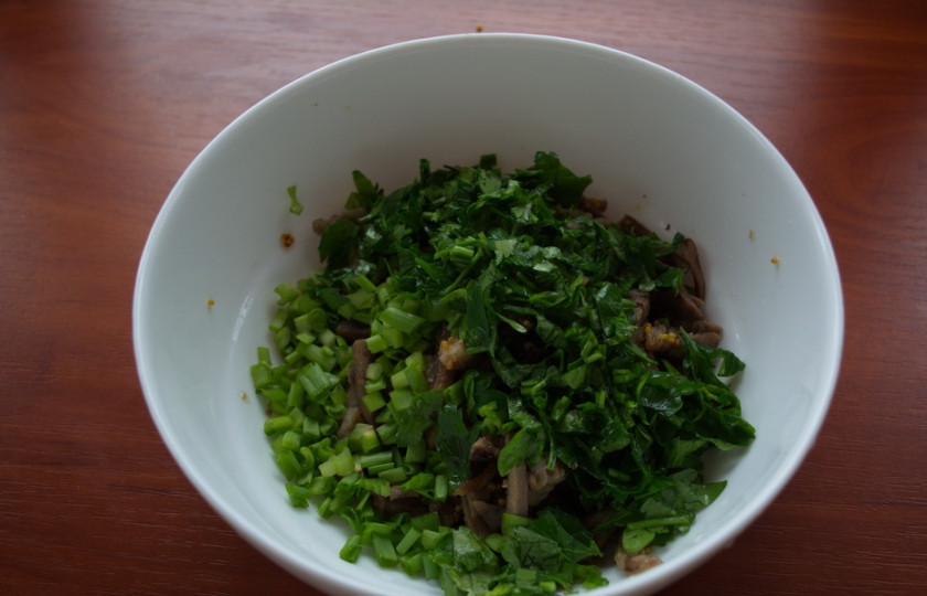 1. Этап. Салат с говядиной и сыром: Возвращаем мясо в миску. Добавляем измельченную зелень петрушки и лука.