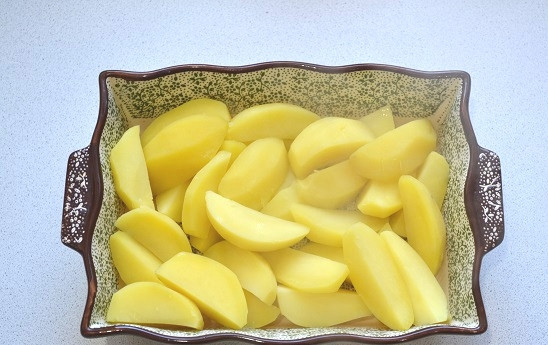 1. Этап. Картофель в заливке: 7. С картофеля слейте воду и выложите его в форму для запекания.