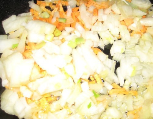 1. Этап. Щи донские с рыбой: Пока картошка варится, лук мелко порежьте, а морковку натрите на терке. Обжарьте овощи в масле до золотистого цвета.