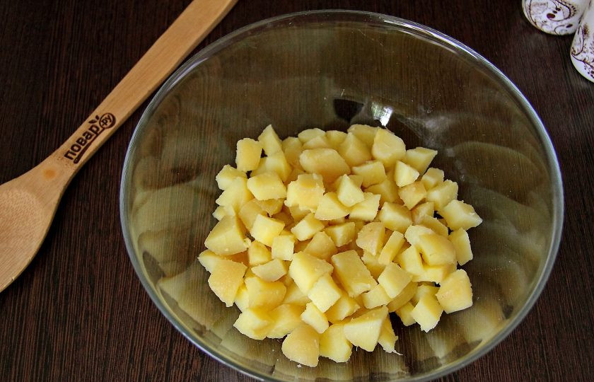 1. Этап. Салат из рыбных консервов с огурцом: Картофель, сваренный в кожуре, очистите и нарежьте небольшими кубиками.